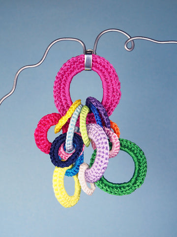 Utopia brooch in blue and multicolour - made from crocheted polyester threads and sterling silver hooks.