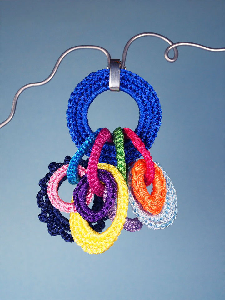 Zenith brooch in blue and multicolour - made from crocheted polyester threads and sterling silver hooks.
