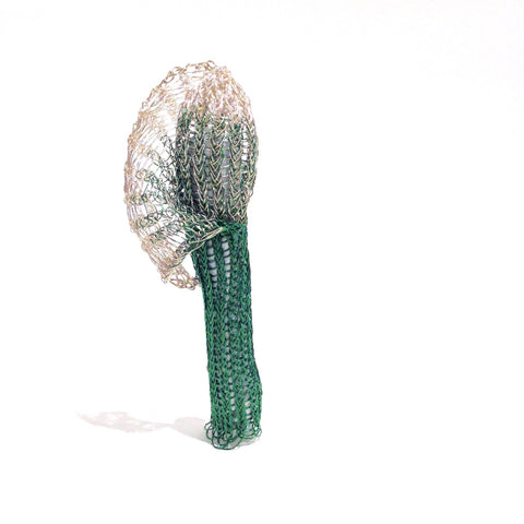 Green and silver On Being Female brooch with coloured copper wire, copper, brass, spandex and tampons.
