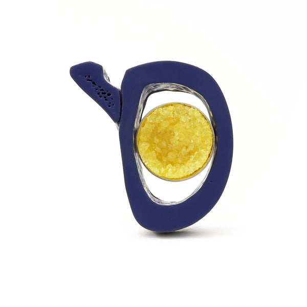 What Remains - Brooch of lacquered dark blue bovine bone with yellow crystal, sterling silver, and nickel silver.