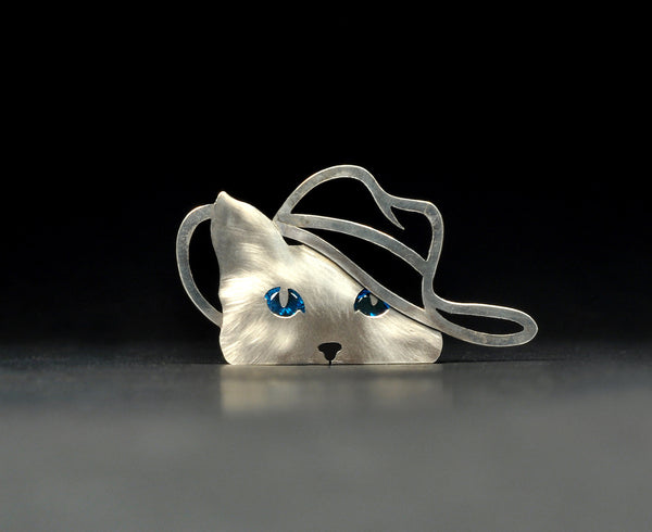 Claudine. Sterling silver cat with sparkling blue cubic zirconia eyes and cut-out cowboy hat. This pin has two locking pin backs.