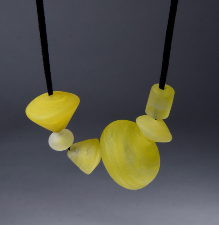Asymmetric Beaded Necklace. Necklace of blown glass and solid glass beads in yellow, on an adjustable length suede leather cord.