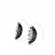 Dahlia, large and breathtakingly light drop earrings of sterling silver and silver with an oxide patina. The petals radiate with lively energy from the play of the negative space with the two colours.  3.5 x 1 cm 