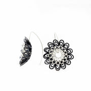 Dahlia, large and breathtakingly light drop earrings of sterling silver and silver with an oxide patina. The petals radiate with lively energy from the play of the negative space with the two colours.  3.5 x 1 cm 