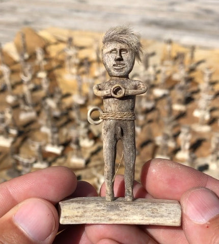 Small man with hair holding ring