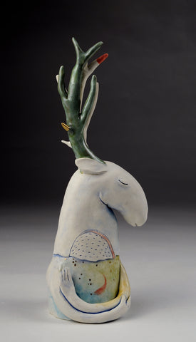 Holding a Moment - ceramic sculpture of cone 6 stoneware finished with glazes and underglazes. A deer-like figure closes its eyes, its arms embracing something invisible, or itself.