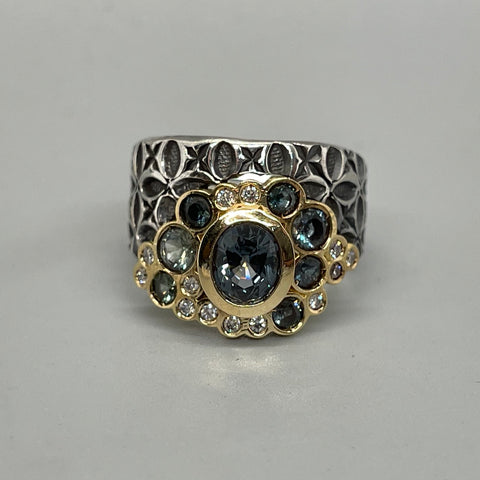 Hand stamped sterling silver ring with a bubble of stunningly coloured Montana sapphires, diamonds, and 18k gold. 