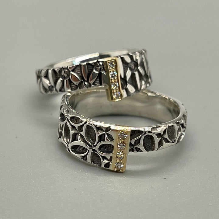 Stamped sterling silver ring. A band of diamonds and 18kt yellow gold joins two asymmetrical square ends. (Bottom in photo)