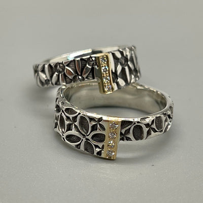 Stamped sterling silver ring. A band of diamonds and 18kt yellow gold joins two asymmetrical square ends. (Bottom in photo)