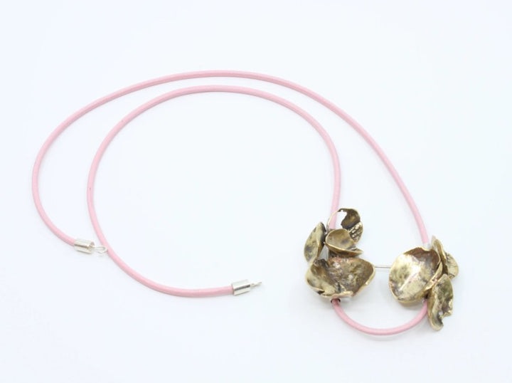 Necklace, bronze and sterling silver on a leather cord.