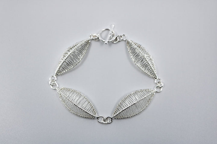 Petal bracelet, hand-woven in sterling silver.   8.5" long