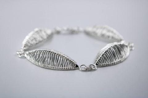Petal bracelet, hand-woven in sterling silver.   8.5" long