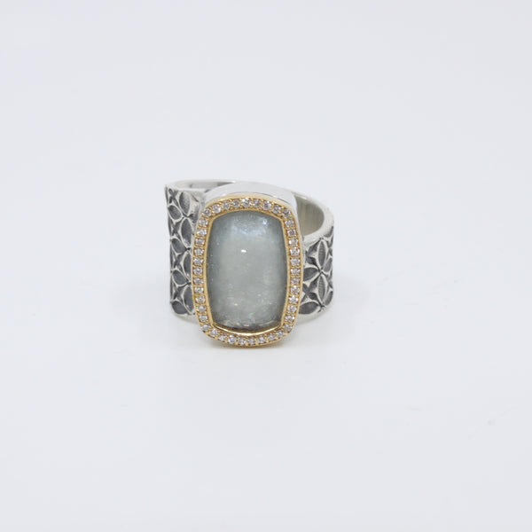 Hand stamped sterling silver ring with a large aquamarine encased in 18K yellow gold and diamonds.   Size 7