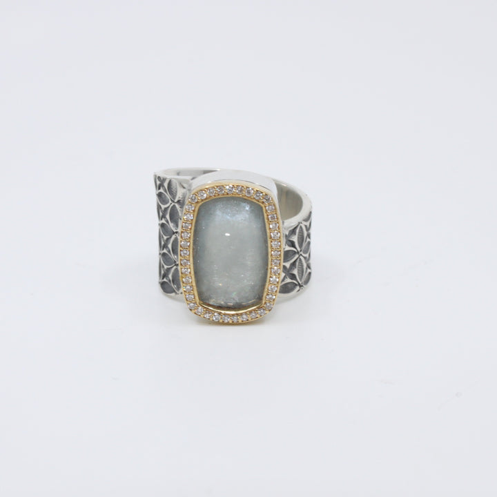 Hand stamped sterling silver ring with a large aquamarine encased in 18K yellow gold and diamonds.   Size 7