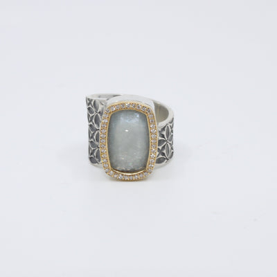 Hand stamped sterling silver ring with a large aquamarine encased in 18K yellow gold and diamonds.   Size 7