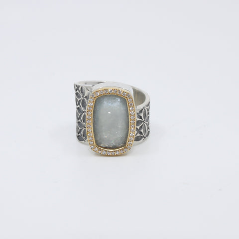 Hand stamped sterling silver ring with a large aquamarine encased in 18K yellow gold and diamonds.   Size 7