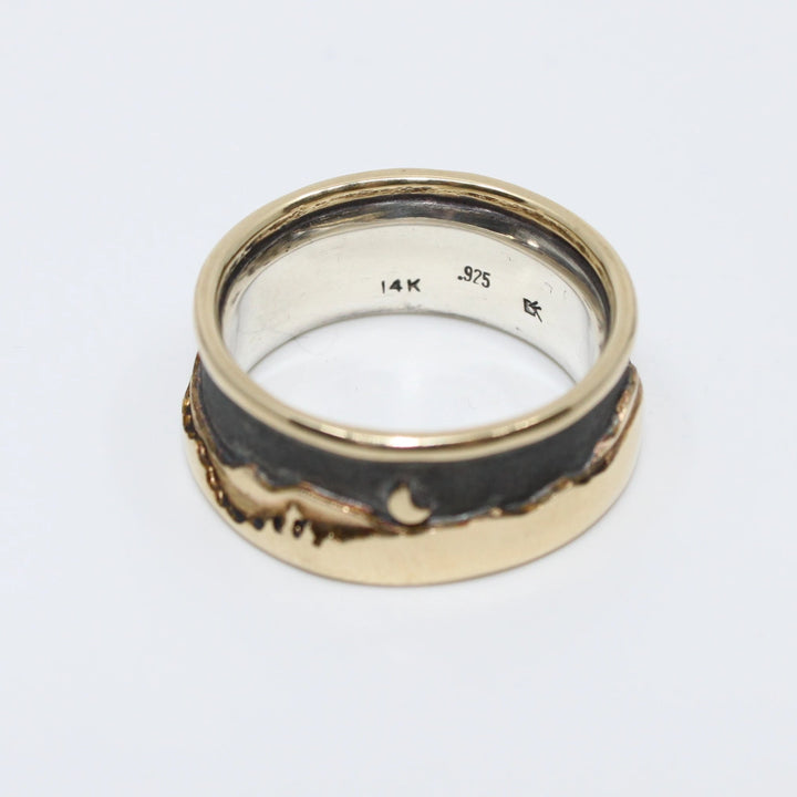 Landscape at night ring with a soft black sky showing beautifully the layers of detail in the 14K gold hills, trees and water with an island, a full and a half moon. Size 9 with a 9.5 mm width.Landscape at night ring with a soft black sky showing beautifully the layers of detail in 14K gold