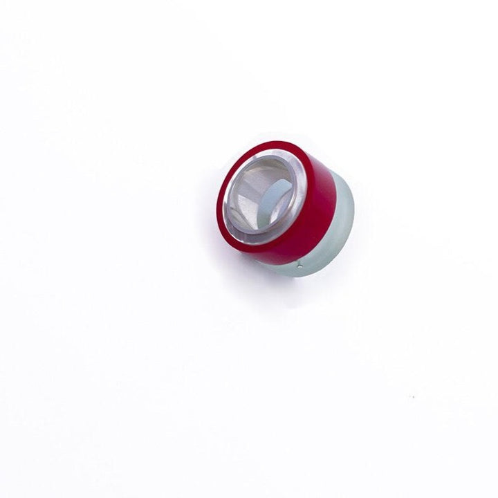 Scrying Ring in sterling silver with hand-cut acrylic and mother-of-pearl. "I like to find the balance between colour and texture. With the term 'scrying' I reference a very old idea with both the natural iridescence of mother of pearl and the poreless man-made surface of machine grade acrylics. I'm very excited about this RED, purposely chosen in pursuit of a NASA red. 