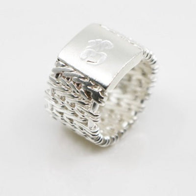 Sterling silver woven ring with an om symbol in a size 6.5