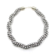 Eternal necklace, 2022. Swarovski pearls and clear crystals are braided into an elegant form using traditional Japanese kumihimo braiding. The clasp is made from woven sterling silver.