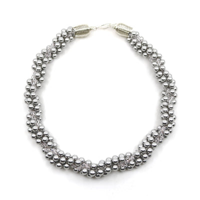 Eternal necklace, 2022. Swarovski pearls and clear crystals are braided into an elegant form using traditional Japanese kumihimo braiding. The clasp is made from woven sterling silver.