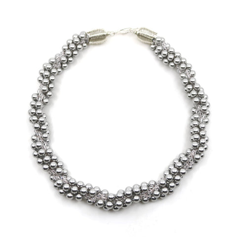 Eternal necklace, 2022. Swarovski pearls and clear crystals are braided into an elegant form using traditional Japanese kumihimo braiding. The clasp is made from woven sterling silver.