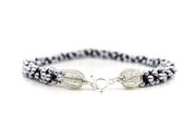Royal necklace, 2022. Swarovski pearls and dark red crystals are braided into an elegant form using traditional Japanese kumihimo braiding. The clasp is made from woven sterling silver.