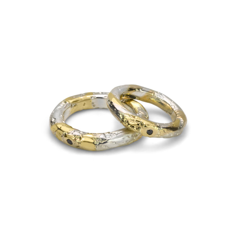 Core Sample Ring in sterling silver with 14k yellow gold and a 3pt round black diamond. Each torus band is approximately 5mm wide. 