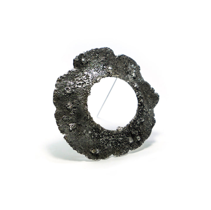Sample-Collection Drill Hole Brooch in sterling silver, 14K yellow gold and stainless steel.