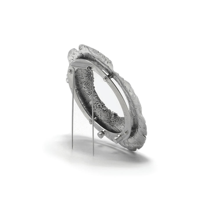 Sample-Collection Drill Hole Brooch in sterling silver, 14K yellow gold and stainless steel.