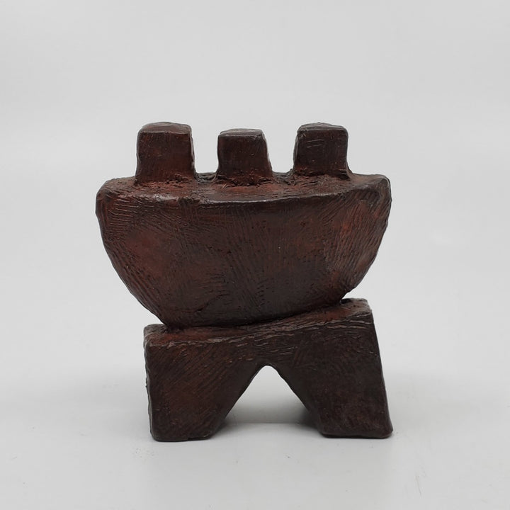 Joie sculpture in bronze. The minimalist shape of this piece is complimented by the ornate etching that covers the sculpture.   9 x 8 x 4 cm