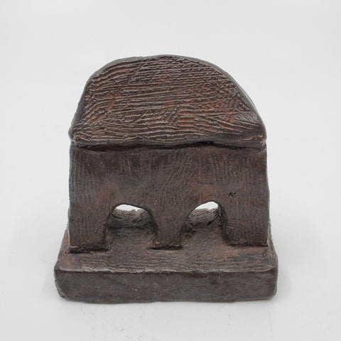 Jumeau sculpture in bronze. The minimalist shape of this piece is complimented by the ornate etching that covers the sculpture.   8 x 8 x 4 cm