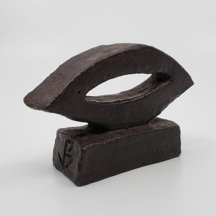 La Lumière sculpture in bronze. The minimalist shape of this piece is complimented by the ornate etching that covers the sculpture.   8 x 11 x 4 cm