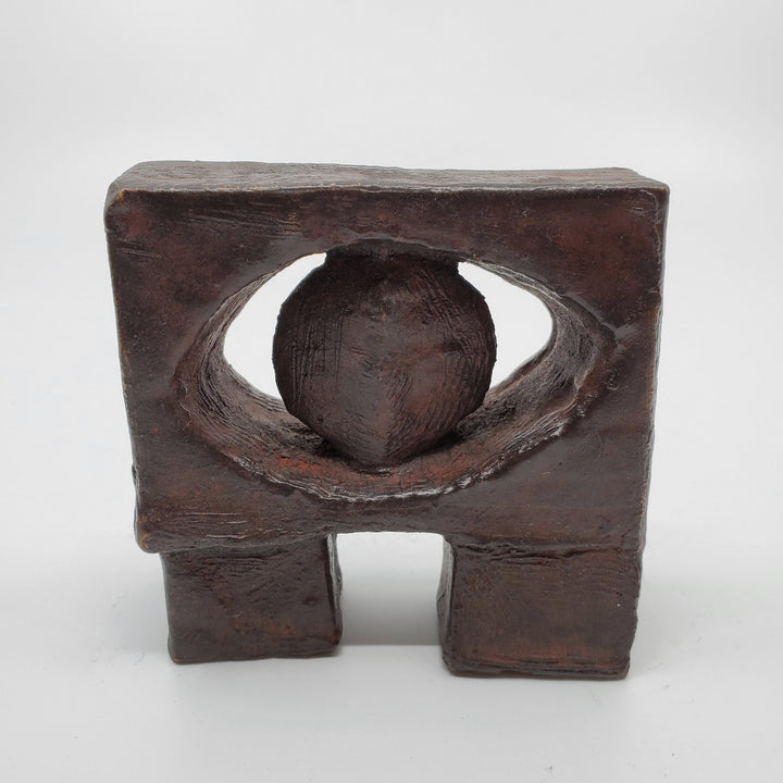 Le Guardien sculpture in bronze. The minimalist shape of this piece is complimented by the ornate etching that covers the sculpture.   8 x 8 x 3 cm