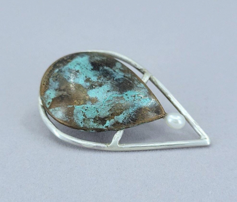 “Leaf Line” Lapel Pin - Sterling silver and copper lapel pin, coloured with a cupric nitrate patina and dotted with a freshwater pearl.