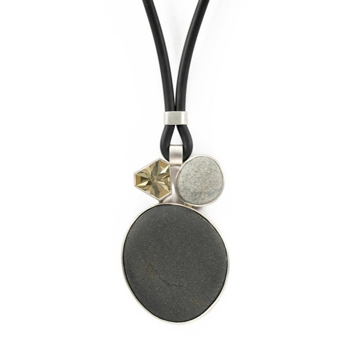Lime quartz and pebble stone pendant in sterling silver on a rubber cord.,