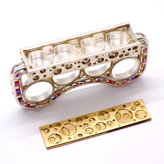 Brass Knuckles-shaped Ring - Silver casted bronze knuckle rings embellished with synthetic zircon beads in a variety of colous with a detachable platform.   Size 7, 94.9 x 21.7 x 46.8mm, 2022.