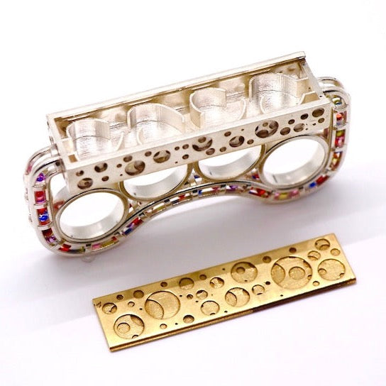 Brass Knuckles-shaped Ring - Silver casted bronze knuckle rings embellished with synthetic zircon beads in a variety of colous with a detachable platform.   Size 7, 94.9 x 21.7 x 46.8mm, 2022.