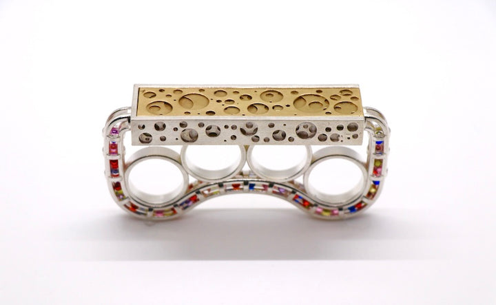 Brass Knuckles-shaped Ring - Silver casted bronze knuckle rings embellished with synthetic zircon beads in a variety of colous with a detachable platform.   Size 7, 94.9 x 21.7 x 46.8mm, 2022.