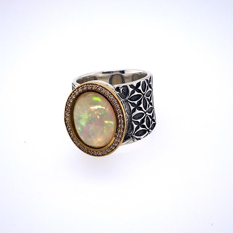 Opal ring on a thick sterling silver band embellished with 18k gold and diamonds