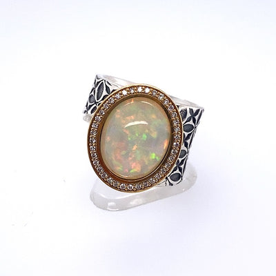 Opal ring on a thick sterling silver band embellished with 18k gold and diamonds