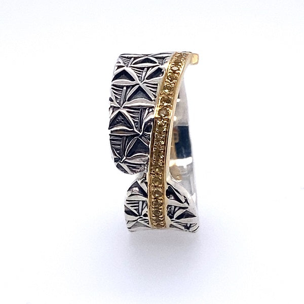 Hand stamped sterling silver ring with a line of yellow sapphires and 18k gold.