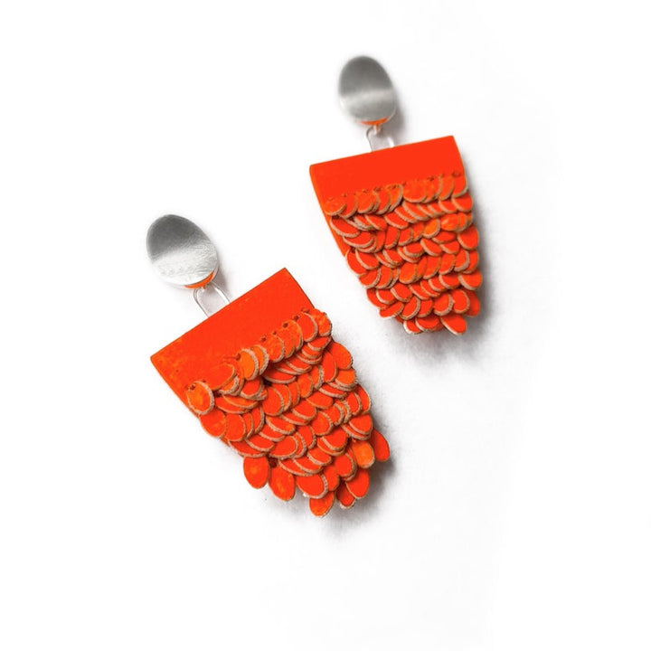 Orange half oval earrings, made from sterling silver, wood, paper, cotton and pigments   2.8 x 5 x 0.6 cm each 