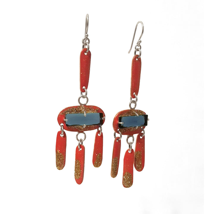 Pink and Gold Glitter Dangle with Blue Stones. The glitter resin-decorated copper is centered with lab-created blue topaz, and has sterling silver shepherd hoops.