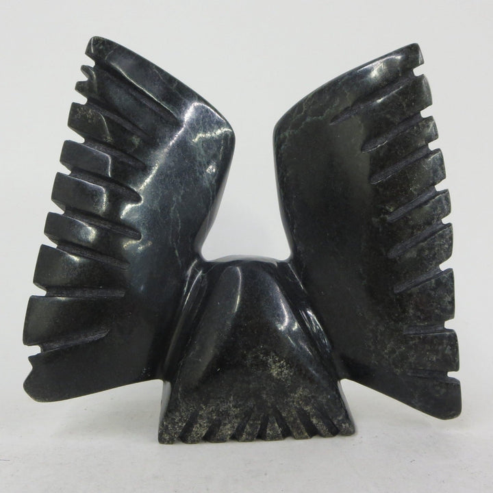 Owl with wings upraised soapstone carving by Matt Oshutsiaq of Cape Dorset, Nunavut. 14 x 16 x 6 cm.back view