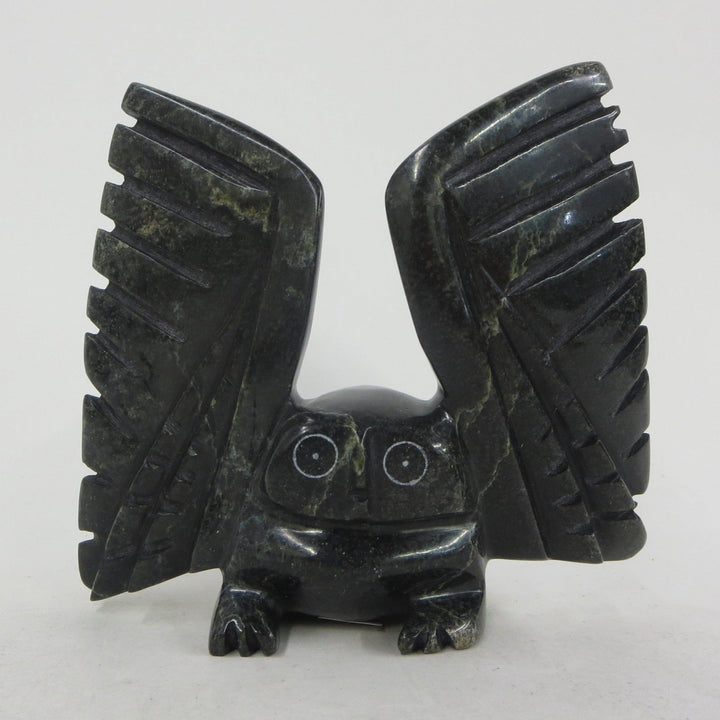 Owl with wings upraised soapstone carving by Matt Oshutsiaq of Cape Dorset, Nunavut. 14 x 16 x 6 cm.