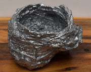 Leaden, ﻿a nest cast in lead on a free-floating lath shelf.  Series of 10 nests, each sold separately.  "A year in paces, a morning ritual of walking has led me to collect numerous bird nests from the thickets along Ottawa’s waterways. In this piece, I have cast each nest in lead salvaged from the torn out ironwork of Parliament Hill— an act of preservation at the perceived fragility of a tiny sanctuary and an exploration of the weighted concept of home and domesticity."
