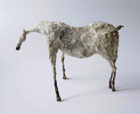 mixed-media sculpture of a horse made from metal and paper