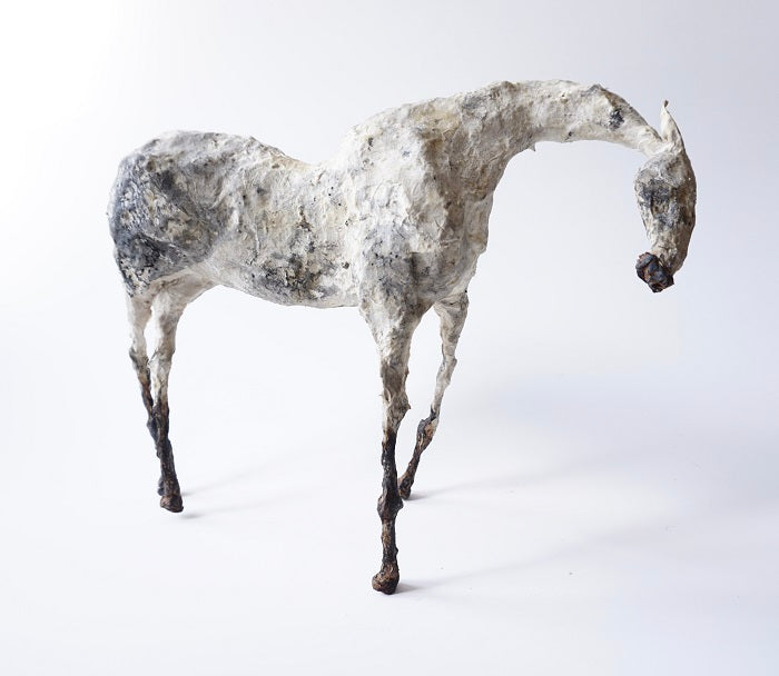 mixed-media sculpture of a horse made from metal and paper