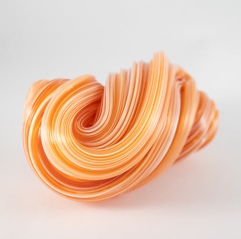 Orange Creamsicle - Glass sculpture. In a large graceful sweep, this one of a kind sculpture measures 13 x 8 x 8 cm. 